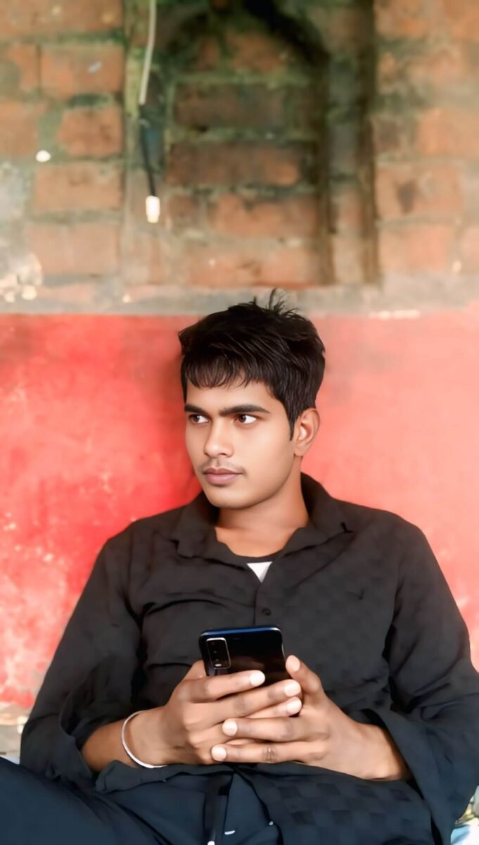 Young man holding smartphone, simple background, casual look, natural portrait photo