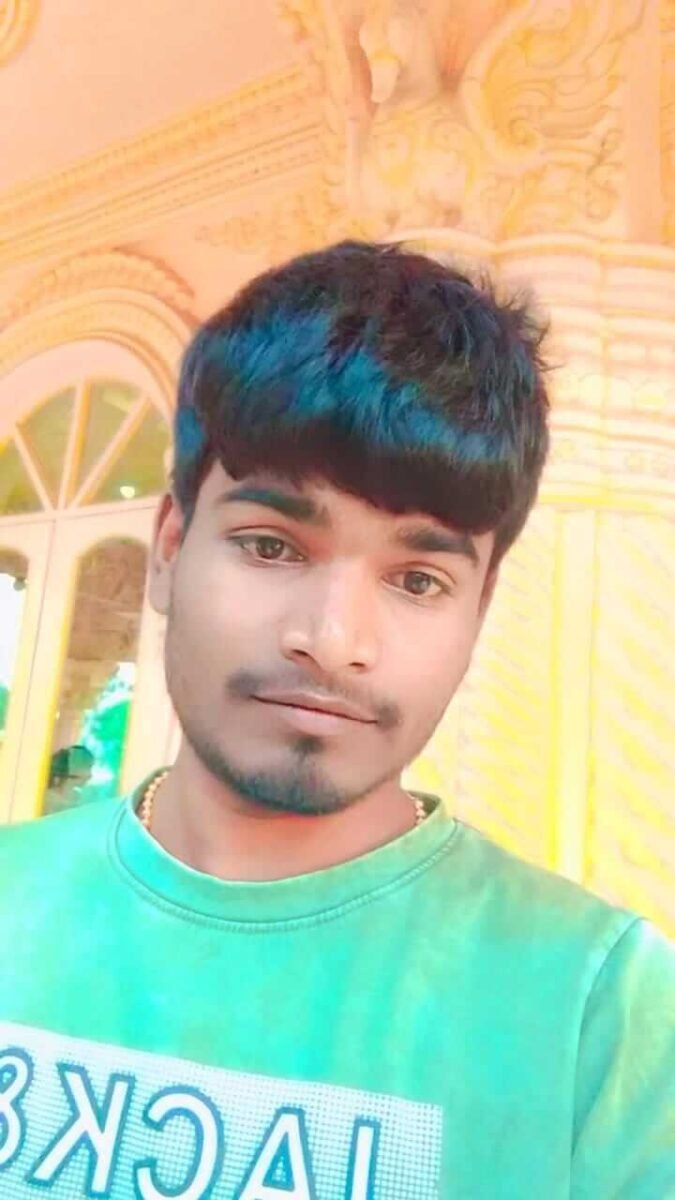 young Indian man portrait selfie with short hairstyle and natural background